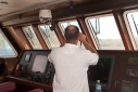 Captain Kostas Andreeou on the bridge as Allure Shadow approaches Dominica