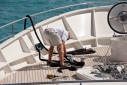 Deckhand preparing a rope on the foredeck of Big Aron