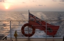 View of ensign from the stern of Island Explorer Catamaran