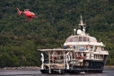 Atmosphere's helicopter leaving the yacht to pick up the guests